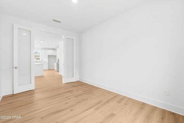 spare room featuring light hardwood / wood-style flooring