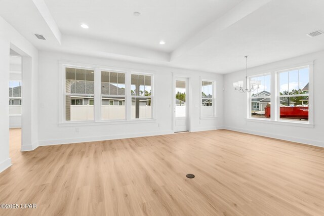 interior space featuring an inviting chandelier and a tray ceiling