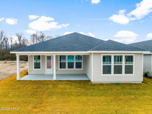 back of house featuring a patio area and a lawn