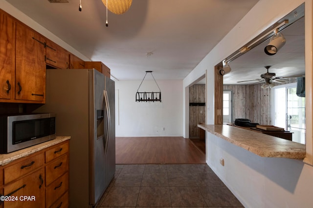 kitchen with ceiling fan, appliances with stainless steel finishes, dark hardwood / wood-style floors, and hanging light fixtures