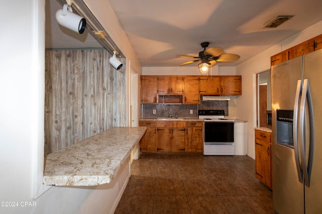 kitchen featuring tasteful backsplash, white electric range oven, stainless steel fridge with ice dispenser, wooden walls, and ceiling fan