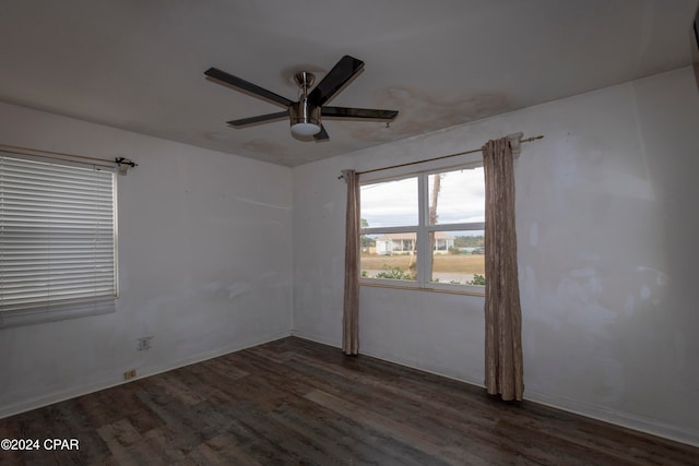 empty room featuring ceiling fan and dark hardwood / wood-style floors