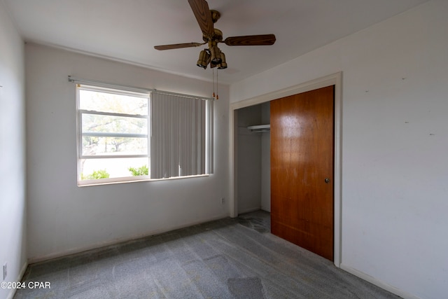 unfurnished bedroom featuring ceiling fan, carpet flooring, and a closet