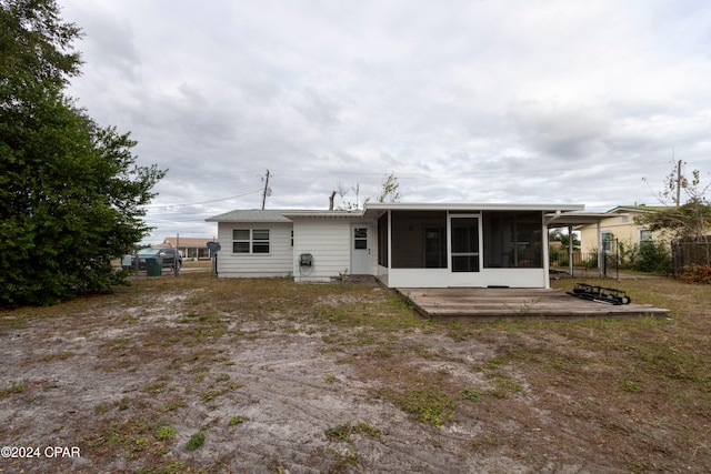 rear view of house featuring a sunroom and a patio area