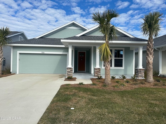 view of front of house featuring a garage and a front lawn