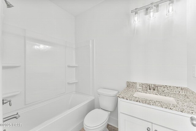 full bathroom featuring vanity, bathtub / shower combination, and toilet