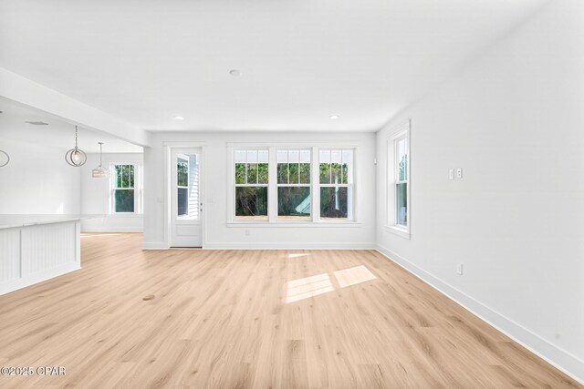 unfurnished living room with light wood-type flooring