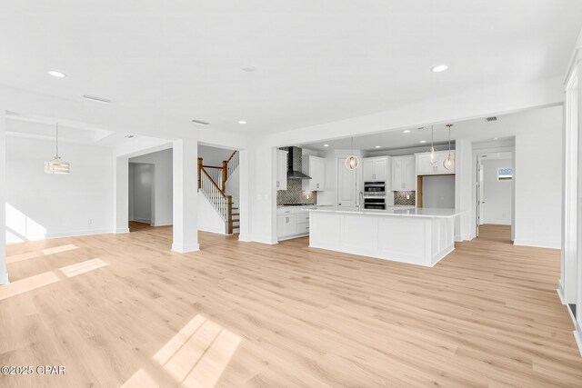 unfurnished living room featuring light wood-type flooring