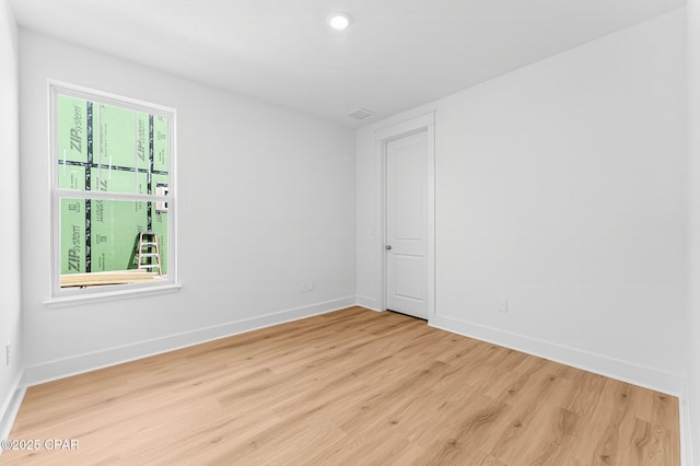 spare room featuring light wood-type flooring