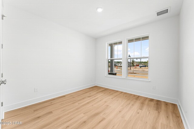 spare room featuring light hardwood / wood-style floors