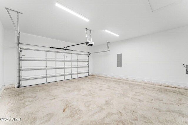 garage with a garage door opener and electric panel