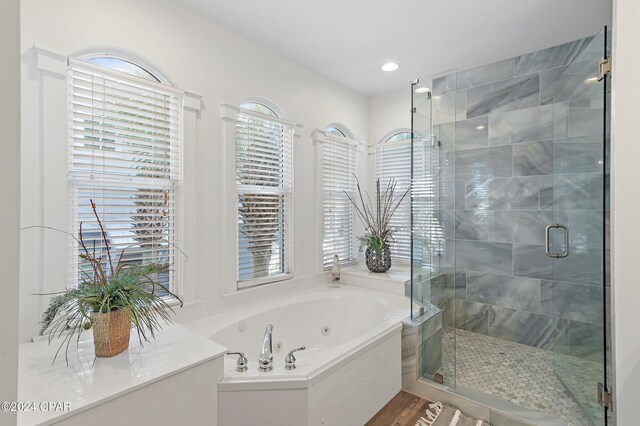 bathroom with plus walk in shower and wood-type flooring