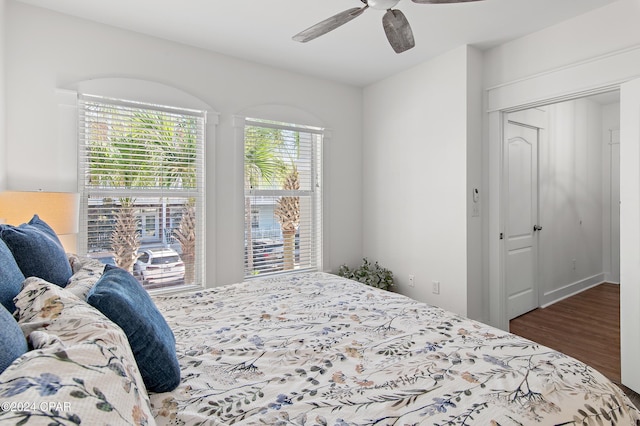 bedroom featuring ceiling fan, a closet, and dark wood-type flooring