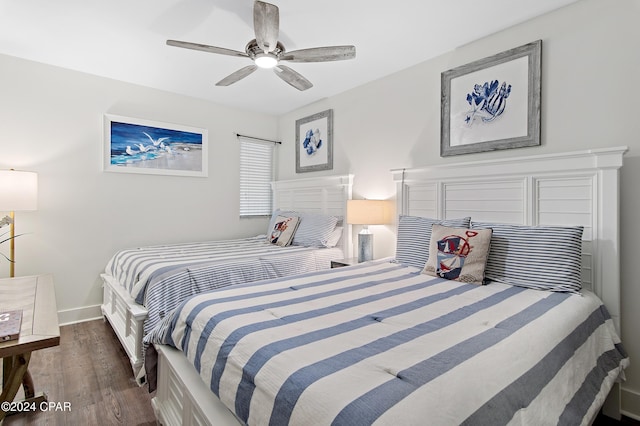 bedroom with ceiling fan and dark hardwood / wood-style flooring