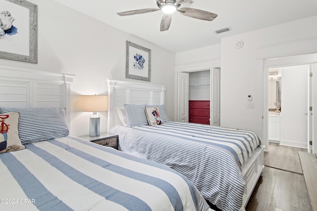 bedroom with wood-type flooring, ensuite bath, a closet, and ceiling fan