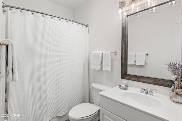 bathroom with vanity, toilet, and walk in shower