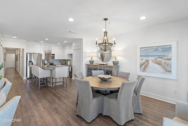 dining room featuring a notable chandelier and dark hardwood / wood-style floors