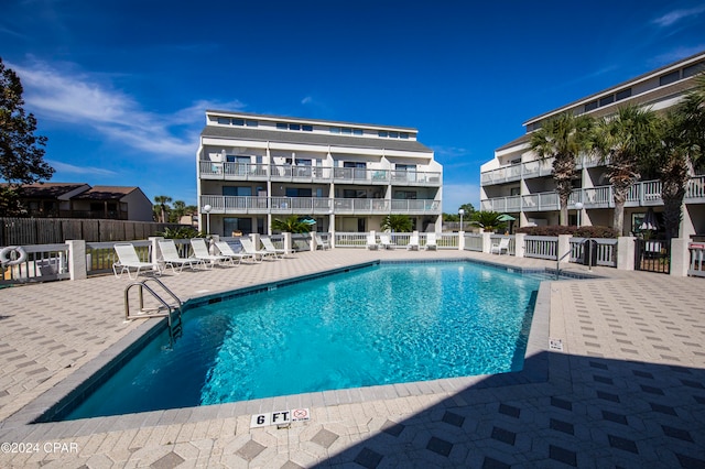 view of swimming pool featuring a patio