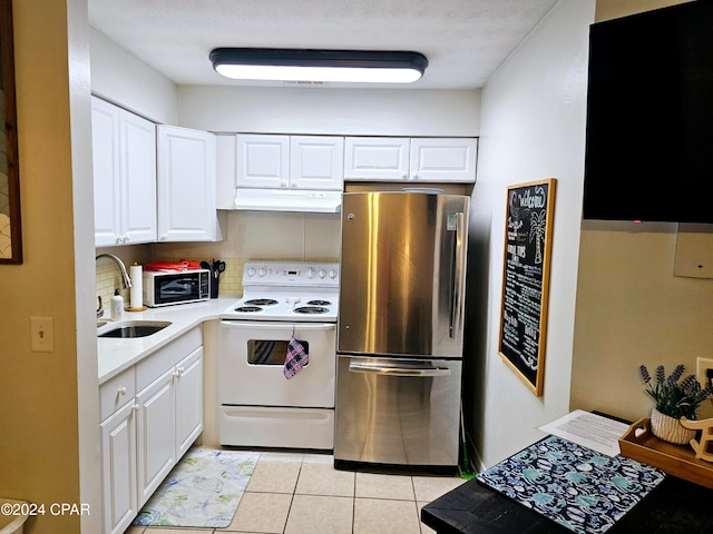 kitchen with white appliances, backsplash, sink, light tile patterned flooring, and white cabinetry