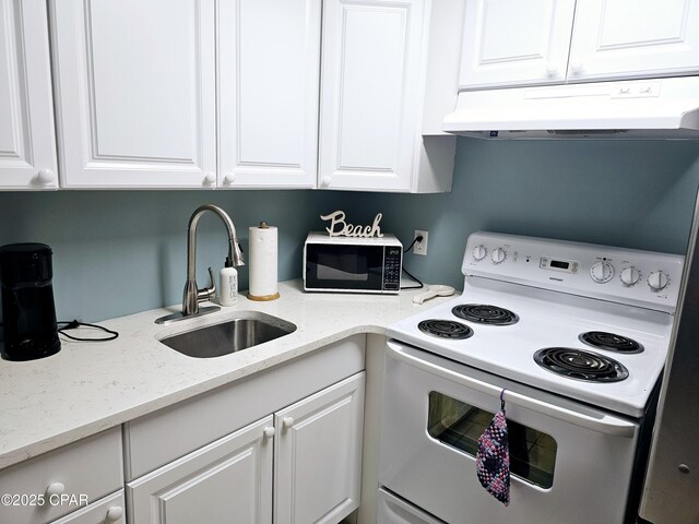 kitchen with white cabinetry, sink, light stone countertops, and white electric range oven