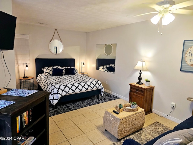 tiled bedroom featuring ceiling fan