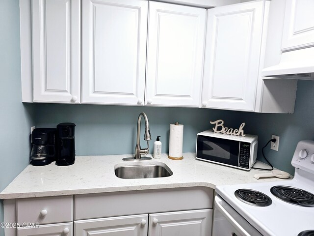 kitchen featuring electric stove, light stone countertops, sink, and white cabinets