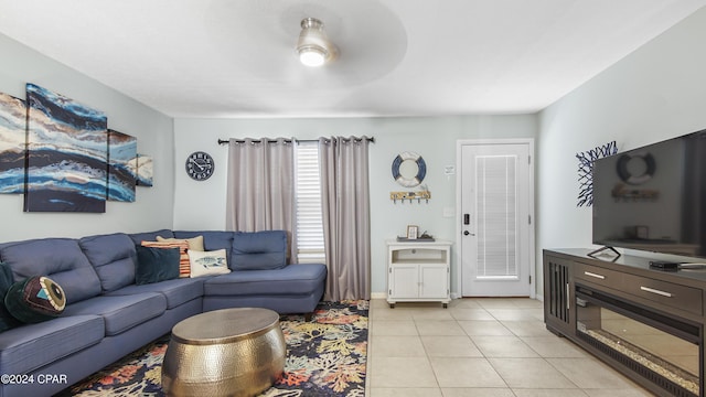 living room with light tile patterned flooring, a ceiling fan, and baseboards