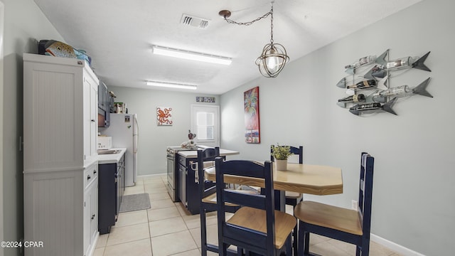 dining space featuring light tile patterned flooring and visible vents