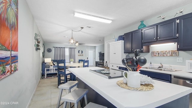 kitchen featuring a kitchen island, light countertops, light tile patterned floors, white microwave, and dishwasher