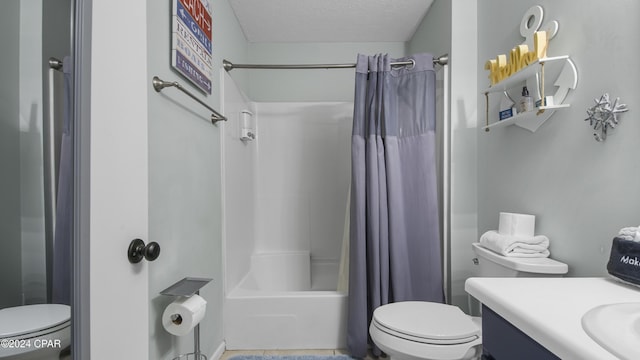 full bath featuring shower / bath combo with shower curtain, a textured ceiling, toilet, and vanity