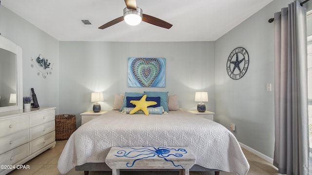 bedroom featuring light tile patterned flooring, a ceiling fan, visible vents, and baseboards