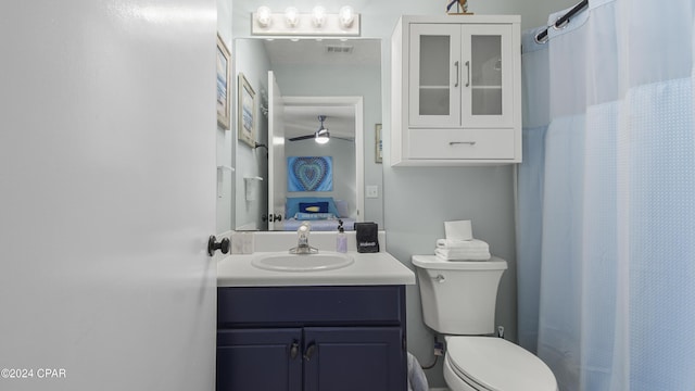 full bath with vanity, toilet, a shower with curtain, and visible vents