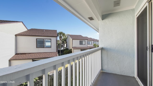 balcony featuring visible vents and a residential view