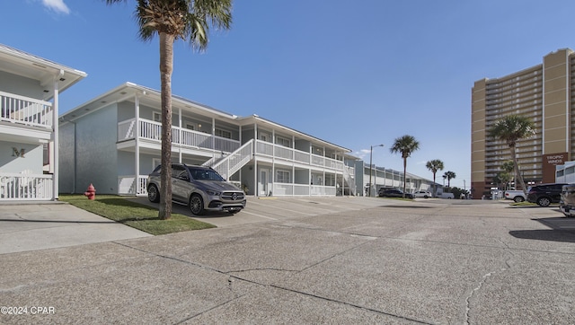 view of building exterior with uncovered parking