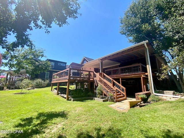 back of house with a yard and a wooden deck