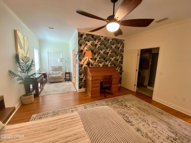 interior space with hardwood / wood-style flooring, ceiling fan, and crown molding