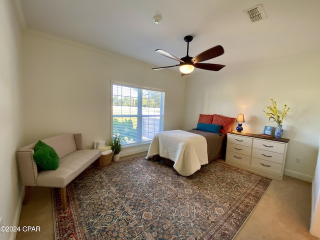 bedroom featuring carpet flooring, ceiling fan, and crown molding