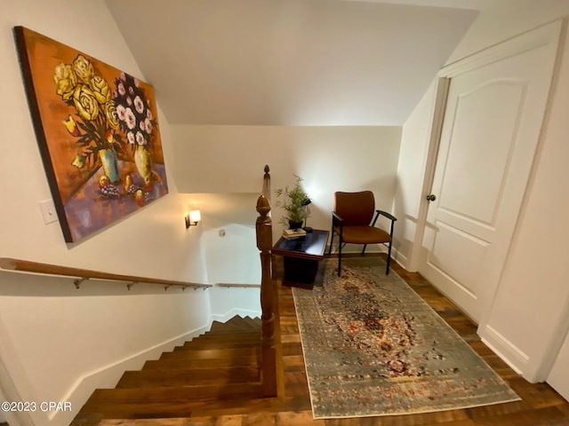 sitting room featuring dark wood-type flooring and lofted ceiling