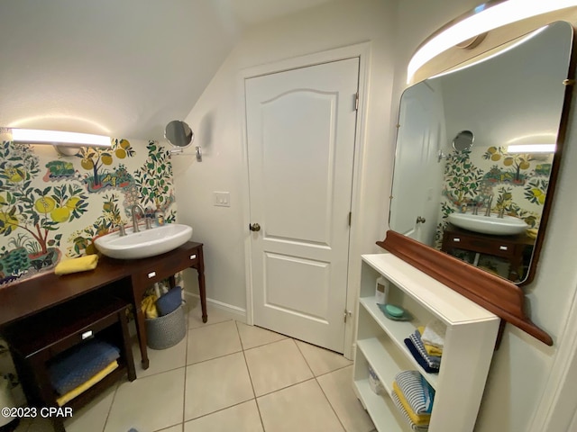 bathroom featuring tile patterned flooring, vanity, and vaulted ceiling