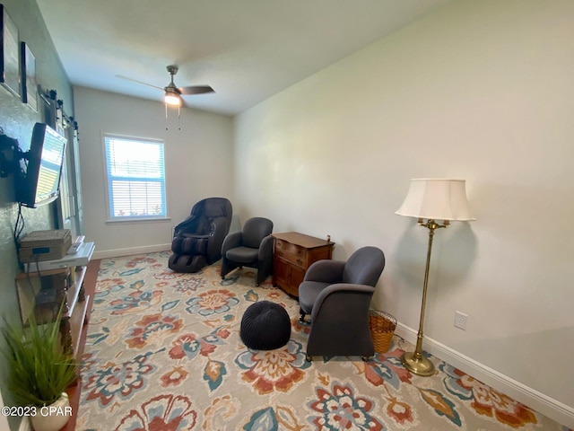 sitting room featuring ceiling fan