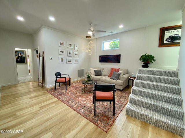 living room featuring ceiling fan and light hardwood / wood-style flooring