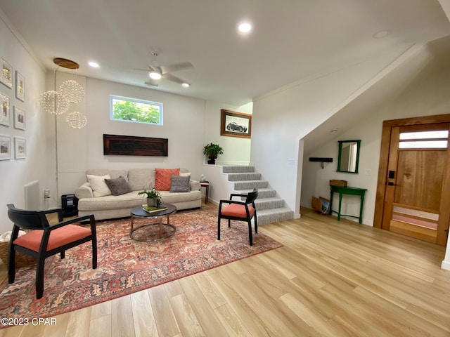 living room with ceiling fan, light hardwood / wood-style floors, and crown molding