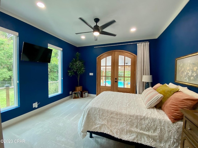 carpeted bedroom with access to outside, ceiling fan, and french doors