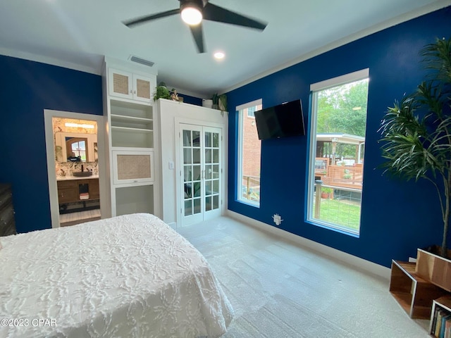 carpeted bedroom featuring ceiling fan and connected bathroom