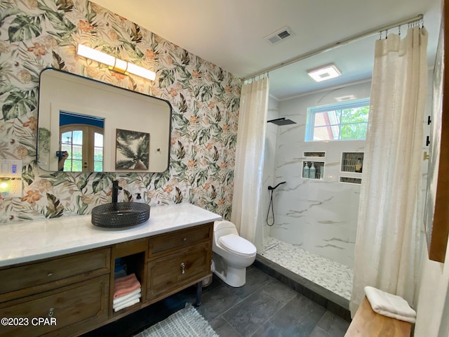 bathroom featuring curtained shower, french doors, vanity, and toilet