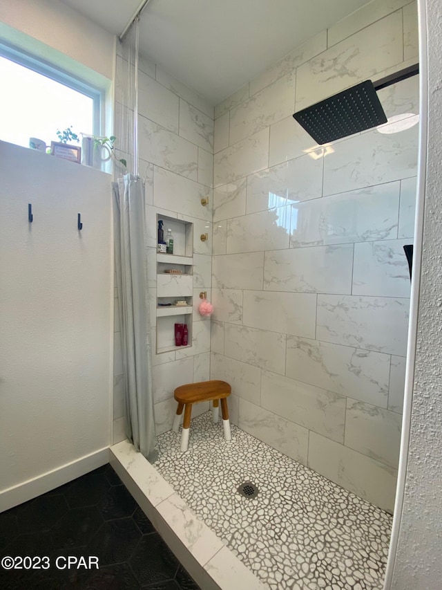 bathroom featuring a shower with shower curtain and tile patterned floors