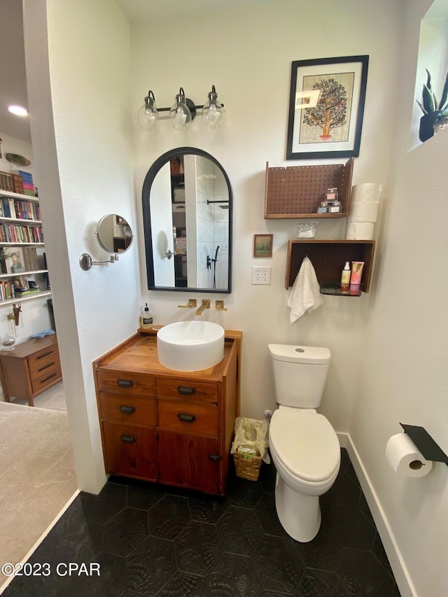 bathroom featuring tile patterned flooring, vanity, and toilet