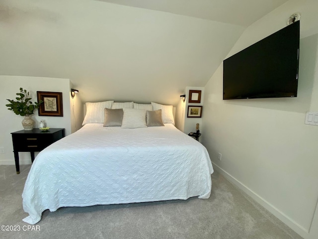 carpeted bedroom featuring vaulted ceiling