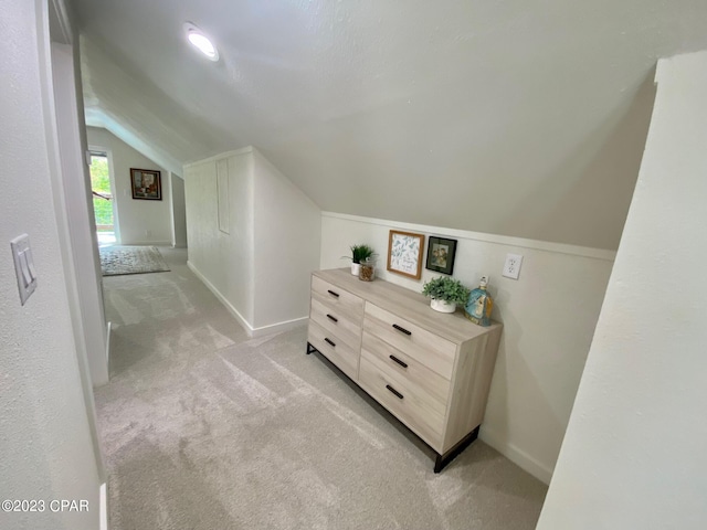 bonus room with light carpet and lofted ceiling