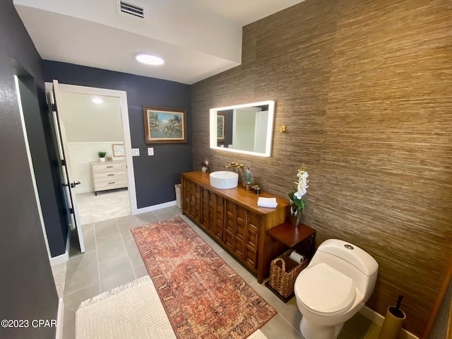 bathroom featuring tile patterned floors, vanity, tile walls, and toilet